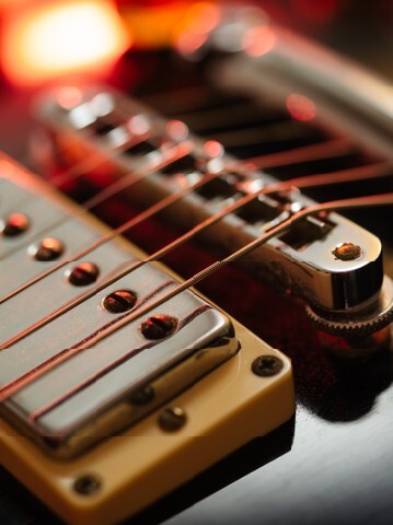 bridge and strings of an electric guitar